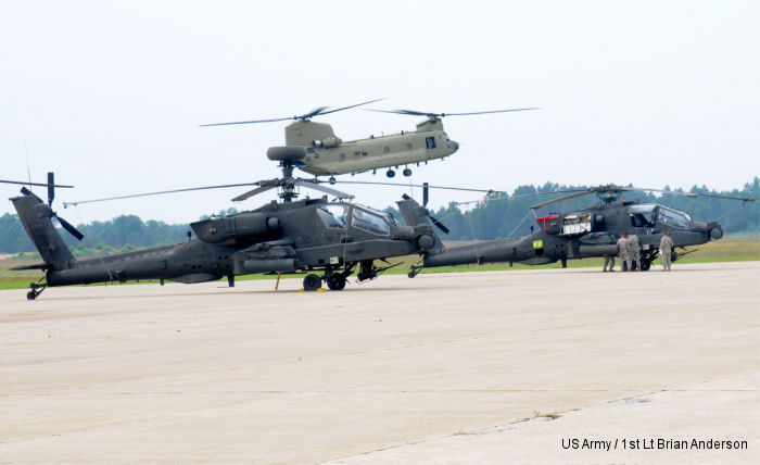1-104th Attack Reconnaissance Battalion AH-64 Apache after a live-fire exercise at the Grayling Air Gunnery Range during Operation Northern Strike 2014. <br> A CH-47 Chinook lands in the background.