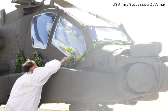 Kahu Kordell Kekoa ceremoniously blesses the AH-64E Apache Guardian and welcomes it to the island for the first time. It is a tradition in the Hawaiian Islands to bless any type of new equipment by sprinkling the item with Hawaiian rain water and brushing it with palm leaves.