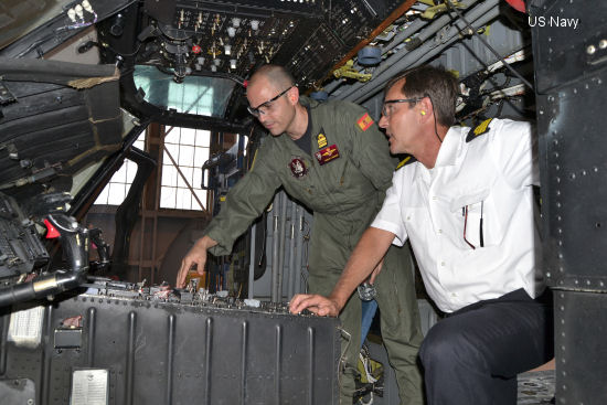 Lt Cmdr Pablo Mendez, a Spanish navy foreign exchange student assigned to Helicopter Maritime Strike Squadron 40 ( <a href=http://www.helis.com/database/sqd/743/>HSM-40</a> ), left, discusses the flight control console of the <a href=/database/model/268/>SH-60F Seahawk</a> helicopter with Spanish Navy Cmdr. Alberto Gonzalez-Cela during a tour of the aircraft at Fleet Readiness Center Southeast (FRCSE) May 13. The Spanish navy is purchasing two helicopters through the Foreign Military Sales program once artisans at FRCSE complete overhauls on the aircraft.