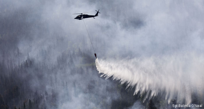 Two 1st Battalion, 207th Aviation Regiment Alaska Army National Guard UH-60 Black Hawk helicopters conducted water bucket drops on the Kenai Peninsula