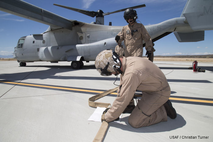 Marines from VMX-22 connect fuel hoses between a MV-22B Osprey and F-35B JSF