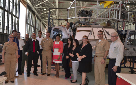 Representatives from Naval Air Systems Command Program Manager Air 299 and Spanish naval officers gather in front of a SH-60F Seahawk helicopter being overhauled at Fleet Readiness Center Southeast May 13. The Spanish navy is purchasing two Seahawk helicopters through the U.S. Foreign Military Sales Program. The helicopters arrived at FRCSE in April from the military aircraft boneyard at Davis-Monthan Air Force Base in Arizona