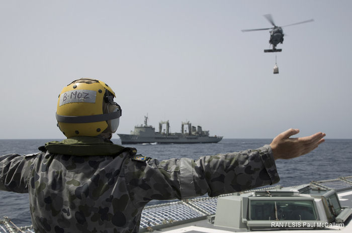 HMAS Success <a href=/database/modelorg/246/>S-70B-2 Seahawk</a> transfer stores while the ships transit the Gulf of Aden.